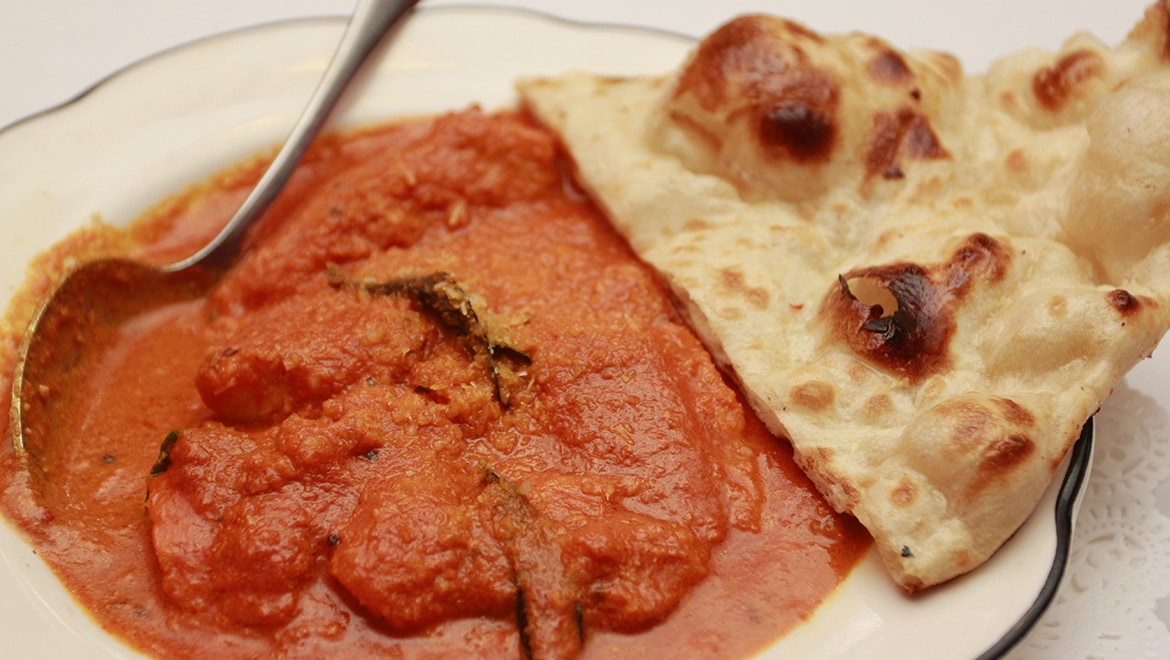 Curry with naan alongside